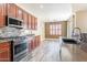 Updated kitchen featuring stainless steel appliances and modern countertops at 44383 W Windrose Dr, Maricopa, AZ 85138