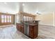 Kitchen island featuring a stainless steel dishwasher that looks out into the living space at 44383 W Windrose Dr, Maricopa, AZ 85138