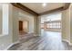 Open-concept living area with wood-look floors, neutral walls, and abundant natural light at 44383 W Windrose Dr, Maricopa, AZ 85138