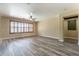 Open living room showcases light-colored walls, modern floors, and plantation shutters at 44383 W Windrose Dr, Maricopa, AZ 85138