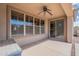 Covered patio with ceiling fan and sliding glass door access to inside the home at 44383 W Windrose Dr, Maricopa, AZ 85138