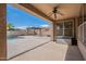 Covered patio boasts ceiling fan, and overlooks backyard with pool, pergola, and fire pit at 44383 W Windrose Dr, Maricopa, AZ 85138