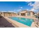 Backyard view of refreshing pool, pergola, and privacy fence at 44383 W Windrose Dr, Maricopa, AZ 85138