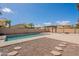 Backyard pool with a pergola, fire pit, and desert landscaping at 44383 W Windrose Dr, Maricopa, AZ 85138