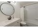 Clean, white bathroom featuring a sleek vanity, round mirror, and shower with a curtain at 4832 E Mineral Rd # 5, Phoenix, AZ 85044