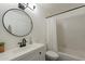 Modern bathroom with white vanity, a round mirror, and a shower with a tub and shower curtain at 4832 E Mineral Rd # 5, Phoenix, AZ 85044