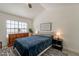 Bright bedroom featuring a comfortable bed, wooden dresser, and a decorative sign at 4832 E Mineral Rd # 5, Phoenix, AZ 85044