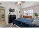 Bright bedroom featuring a television, natural light and a comfortable bed at 4832 E Mineral Rd # 5, Phoenix, AZ 85044