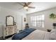 Inviting bedroom features a ceiling fan, large window, a dresser with a mirror and closet at 4832 E Mineral Rd # 5, Phoenix, AZ 85044