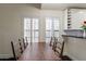 Traditional dining room features a wood table, white cabinets, and windows with plantation shutters at 4832 E Mineral Rd # 5, Phoenix, AZ 85044