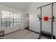 Bright room set up for exercise, featuring a workout machine and large window at 4832 E Mineral Rd # 5, Phoenix, AZ 85044