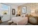 Serene bedroom with decorative wallpaper, accent furniture, and lots of natural light at 514 W Freedom St, Florence, AZ 85132