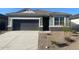 Charming single-story home with neutral gray exterior, rock veneer accents, and a two-car garage at 514 W Freedom St, Florence, AZ 85132