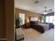 A large main bedroom showcases a queen-size bed, neutral carpeting, a ceiling fan, and plantation shutters at 5426 E Calle De Baca --, Cave Creek, AZ 85331