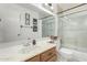 Well-lit bathroom features a shower over bath and wood vanity at 5658 E Fairbrook St, Mesa, AZ 85205