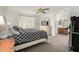 Serene main bedroom with ceiling fan and en-suite bathroom entrance at 5658 E Fairbrook St, Mesa, AZ 85205