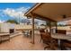 Covered patio boasts outdoor kitchen with built-in grill, perfect for entertaining in style at 5658 E Fairbrook St, Mesa, AZ 85205