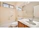 Bathroom featuring a combination tub and shower, tiled backsplash, and single sink vanity at 6198 W Wikieup Ln, Glendale, AZ 85308