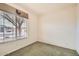 Carpeted bedroom with neutral walls and a window offering natural light and neighborhood views at 6198 W Wikieup Ln, Glendale, AZ 85308