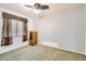 This bedroom features a ceiling fan, window with blinds, and a small closet at 6198 W Wikieup Ln, Glendale, AZ 85308