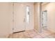 Bright entryway featuring neutral tile flooring, a sidelight window, and access to other rooms at 6198 W Wikieup Ln, Glendale, AZ 85308