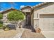 Inviting front entrance with a tiled walkway, desert landscaping, and an attractive exterior at 6198 W Wikieup Ln, Glendale, AZ 85308