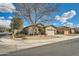 Charming single-story home featuring a xeriscaped front yard with a mature shade tree on a corner lot at 6198 W Wikieup Ln, Glendale, AZ 85308