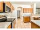 Functional kitchen featuring stainless steel appliances, tile backsplash, and ample counter space at 6198 W Wikieup Ln, Glendale, AZ 85308