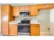 Well-lit kitchen showcases stainless steel appliances, natural wood cabinetry, and neutral color palette at 6198 W Wikieup Ln, Glendale, AZ 85308