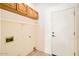 A utilitarian laundry area featuring built in cabinets, a utility sink and a door at 6198 W Wikieup Ln, Glendale, AZ 85308