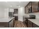 Modern kitchen with stainless steel appliances, granite countertops, and wooden cabinets at 634 W Pintail Dr, Casa Grande, AZ 85122