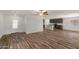 Open-concept living area featuring wood-look floors that flow into the kitchen with a center island at 634 W Pintail Dr, Casa Grande, AZ 85122