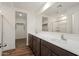 Modern bathroom featuring dual sinks, a large mirror, and a walk-in shower at 635 W Pintail Dr, Casa Grande, AZ 85122