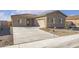 Tan single-story home featuring a concrete driveway, tile roof and low desert landscaping at 635 W Pintail Dr, Casa Grande, AZ 85122