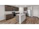 Modern kitchen with stainless steel appliances, gray cabinets, and a center island at 635 W Pintail Dr, Casa Grande, AZ 85122