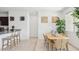 Bright dining area features a wood table, wicker chairs, and luxury vinyl floors at 636 W Freedom St, Florence, AZ 85132