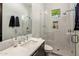 Modern bathroom with a glass-enclosed shower, geometric tiles, and a sleek, white marble countertop sink at 6650 N Hillside Dr, Paradise Valley, AZ 85253