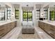 Bright, luxurious bathroom featuring dual vanities, a soaking tub, and large windows at 6650 N Hillside Dr, Paradise Valley, AZ 85253