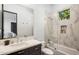 Sleek bathroom with white marble tiles, glass shower, and dark vanity at 6650 N Hillside Dr, Paradise Valley, AZ 85253