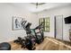 Bright exercise room with modern equipment, hardwood floors, and a view to the backyard at 6650 N Hillside Dr, Paradise Valley, AZ 85253