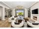 Bright living room with modern decor, fireplace, and sliding glass doors to the outdoor patio at 6650 N Hillside Dr, Paradise Valley, AZ 85253