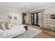 Bright main bedroom with a chandelier, wood floors, and french doors leading to the backyard at 6650 N Hillside Dr, Paradise Valley, AZ 85253