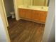 Bathroom featuring double sinks with wood cabinets and modern fixtures, complemented by stylish flooring at 6656 S Classic Way, Gilbert, AZ 85298