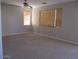 Spacious bedroom with neutral carpet, ceiling fan, and windows with blinds at 6656 S Classic Way, Gilbert, AZ 85298