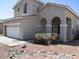 Beige single-story home featuring an attached two-car garage and a low-maintenance rock yard at 6656 S Classic Way, Gilbert, AZ 85298