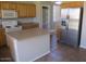 Bright kitchen with stainless steel refrigerator, wood cabinets, and tile floor at 6656 S Classic Way, Gilbert, AZ 85298