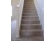 Carpeted staircase with white railing, offering a safe and stylish transition between floors at 6656 S Classic Way, Gilbert, AZ 85298