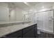 Modern bathroom with a glass-enclosed shower, granite counters, and wood-look flooring at 666 W Pintail Dr, Casa Grande, AZ 85122