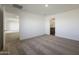 A spacious bedroom featuring neutral carpeting with an adjoining bathroom and closet at 666 W Pintail Dr, Casa Grande, AZ 85122