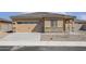 Charming single-story home with a tan exterior, a two-car garage, and low-maintenance desert landscaping at 666 W Pintail Dr, Casa Grande, AZ 85122